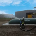 Citerne souple réserve incendie installée en extérieur - Réserve incendie souple installée près d'un bâtiment industriel